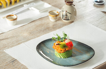 Expertly crafted sushi sits on an elegant plate, surrounded by fresh ingredients. This scene captures the essence of fine dining in a cozy restaurant setting, ideal for special moments