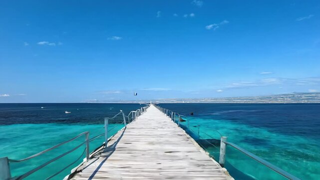 Pier going into the sea, ocean from the island. Beautiful background, creating a spring summer mood and tourism, vacation. Tropical resort Natural landscape background, advertising space, copy space