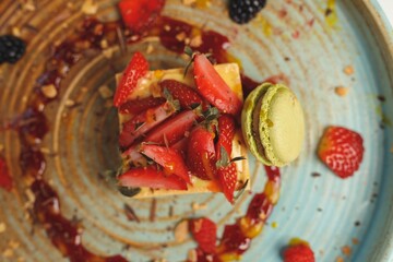 A charming sushi restaurant showcases artistic dishes featuring fresh ingredients, expertly crafted by a renowned chef. Valentine's Day specials include elegant desserts adorned with strawberries