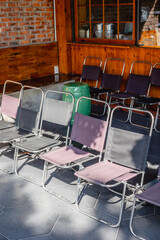 Outdoor seating arrangement with metal folding chairs in a sunlit patio