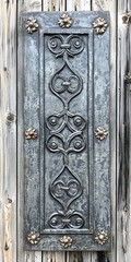 Antique wrought iron panel with medieval scroll designs on wood, detailed corner embellishments, celtic knotwork, crafted metalwork, aged patina