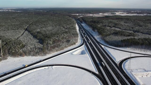 Aerial view of a road junction in a winter landscape. Motorway road junction.