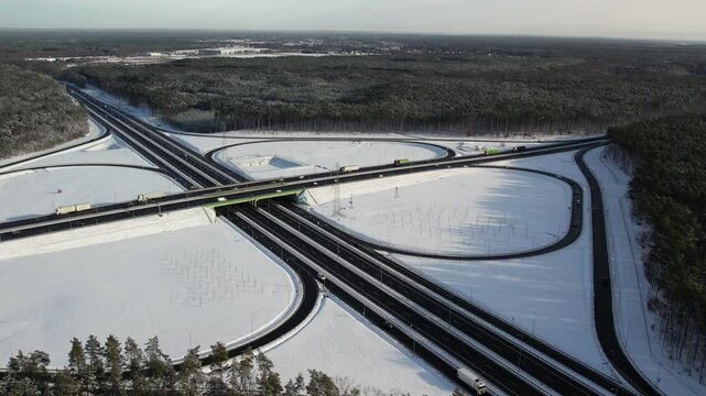 Aerial view of a road junction in a winter landscape. Motorway road junction.
