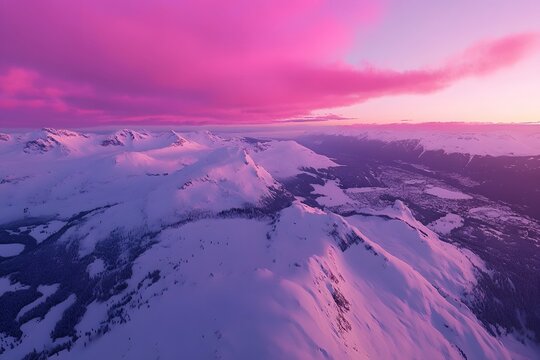 Pink sunset over snowy mountain range, aerial view, winter landscape, travel poster