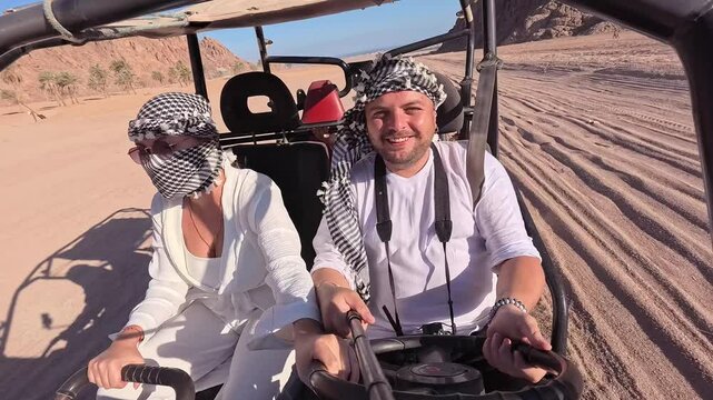 Egyptian activity with off-road vehicles and dust dirt road. Tourists driving on ATV, buggy, quads in the Sahara desert