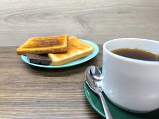 Black coffee in a cup and toast on a plate for breakfast.  high-quality photo