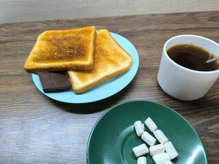 Black coffee in a cup and toast on a plate for breakfast.  high-quality photo