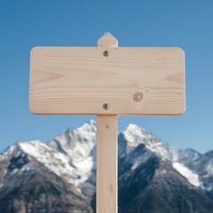 Fototapeta premium Blank Wooden Signpost with Majestic Snow-Capped Mountain Background