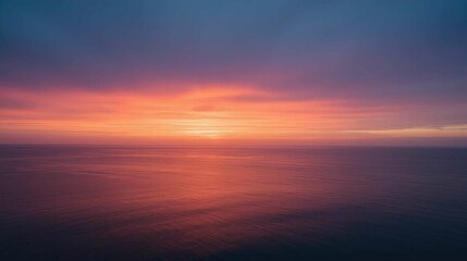 Fototapeta premium Serene Sunset over Calm Ocean Waters with Colorful Sky Reflection
