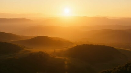 Fototapeta premium Serene Sunrise over Rolling Hills and Misty Landscape at Dawn