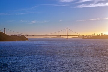 Golden Gate Bridge at sunset with San Francisco skyline in the background