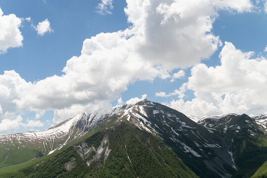 mountain landscape in Georgia.Snow-capped mountain peaks against a blue sky