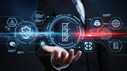 A futuristic digital interface with a hand holding a glowing checklist surrounded by high-tech symbols, warning signs, and global data, symbolizing innovation and cybersecurity.