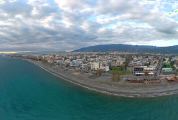 Fototapeta premium Panoramic view of the coast and city of Kalamata in Peloponnese, Greece, at sunset.