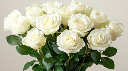 Fototapeta premium A wedding bouquet of white roses and greenery held against a soft ivory background. Elegant and classic.