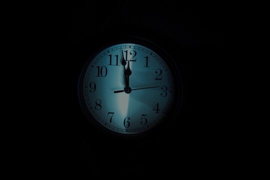 The Doomsday Clock shows two minutes to twelve. The clock is in the dark.