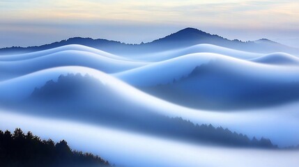 Obraz premium Foggy Mountains at Sunrise Creating Ethereal Waves Across the Landscape