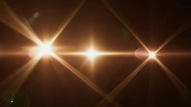 sequence of bright lens flares blinking in opposite directions, with glowing light beams