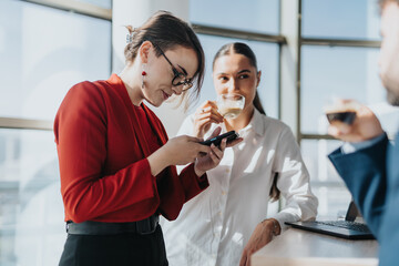 Business employees gather in an office kitchen, enjoying coffee and casual conversation. The setting reflects a modern workplace atmosphere filled with professionalism and camaraderie.