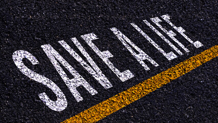 Save a Life concept, On the road line yellow Text Writing save a life on Asphalt word floor ground,...