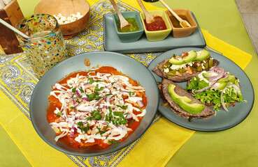 Traditional Yucatecan Mayan lunch - Chilaquiles, tlacoyo,enchilada and sope made with corn dough called masa served with salsa in a traditional mayan cuisine restaurant in Valladolid,Yucatan,Mexico 