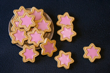 Homemade sweets in the shape of a star, cookies in the shape of a star on a black background....