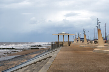 Seafront at Thornton Cleveleys showing the modern curved sea defenses with steps and concrete shelter