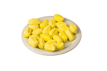 Famous traditional Turkish yellow Mevlana candy (in Turkish: Mevlana Şekeri ) in white plate isolated on a white background. The local confectionery product in Konya, Turkiye. Close up shot
