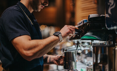 A focused barista skillfully using an espresso machine to make coffee. The ambiance suggests a...