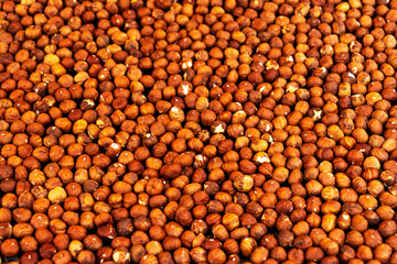 peeled hazelnuts are fried in a frying pan
