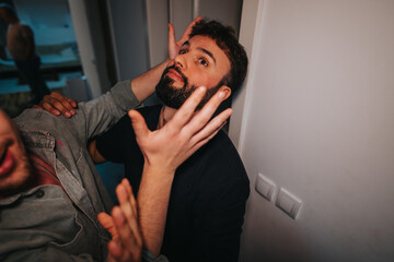 Two friends engage in playful antics in a cozy home environment. Their expressions convey a sense of fun, spontaneity, and lively interaction.