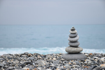 Stacking stones by the seaside.