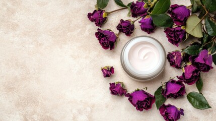 Delicate jar of cream surrounded by dried rose petals and an open oil tin, set on a light beige surface with soft, sunny illumination
