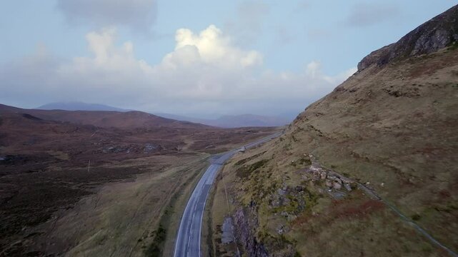 The A835, part of the North Coast 500 touring route passing through Knockan Crag Nature Reserve, Sutherland, Highlands, Scotland, United Kingdom