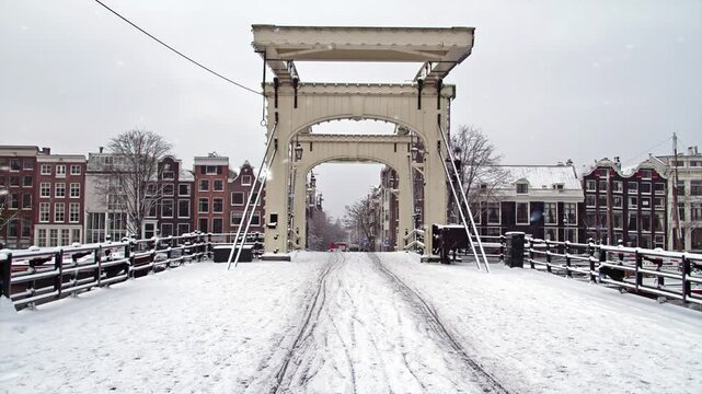 Snowing at the historical Tiny Bridge in winter in the Netherlands