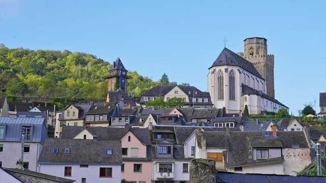 Rooftop tracking shot of Oberwesel town in the early morning, featuring medieval towers, churches, and hilly landscape, Rhine River Valley, Germany