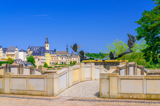 Fontaine aux colombes Fountain with dove of peace sculpture and small bridge in Judiciary Cite judiciaire Justice quarter in Ville Haute quarter with Luxembourg City historical centre background