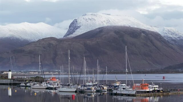 Corpach lighthouse and marina on the shores of Loch Eli with snow capped Ben Nevis and Fort William, Highland region, Scotland, United Kingdom 