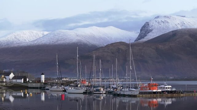 Corpach lighthouse and marina on the shores of Loch Eli with snow capped Ben Nevis and Fort William, Highland region, Scotland, United Kingdom 