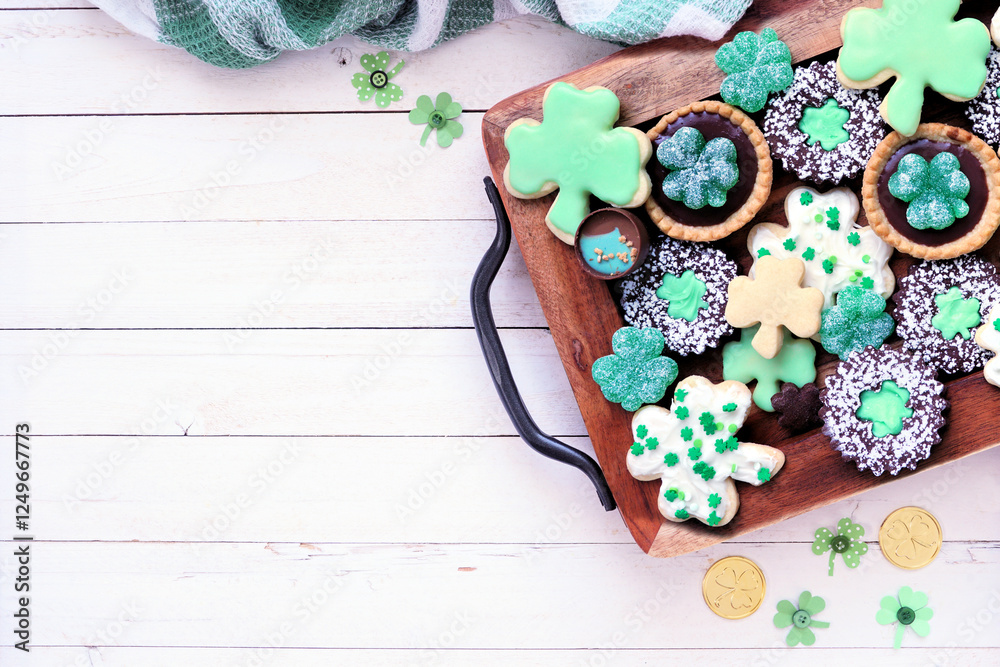 Poster st patricks day shamrock dessert board. green cookies and sweets. above view table scene over a whit