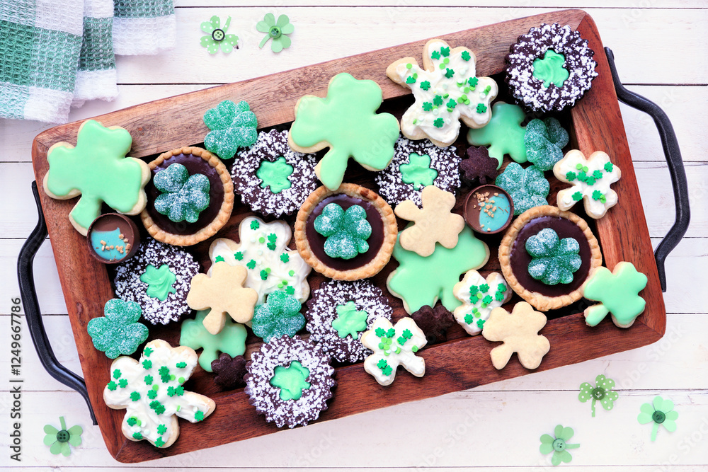 Poster st patricks day shamrock dessert board. green cookies and sweets. top view table scene over a white 