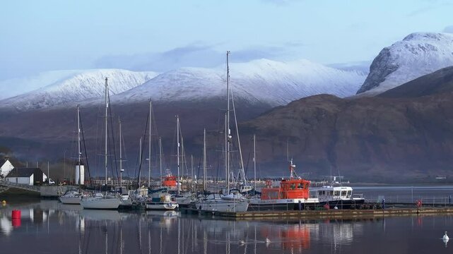 Corpach lighthouse and marina on the shores of Loch Eli with snow capped Ben Nevis and Fort William, Highland region, Scotland, United Kingdom 