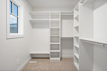 White room with a window and a bench