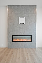 Large fireplace is in the middle of a gray wall