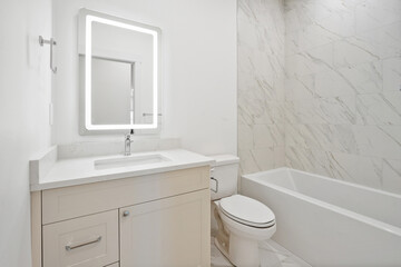 Bathroom with a white toilet, sink, and bathtub