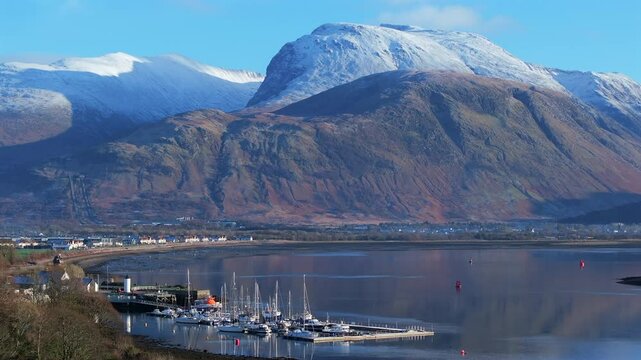 Corpach lighthouse and marina on the shores of Loch Eli with snow capped Ben Nevis and Fort William, Highland region, Scotland, United Kingdom 