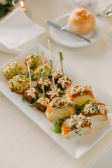 Elegant gourmet appetizers served on a platter at a sophisticated event during the evening