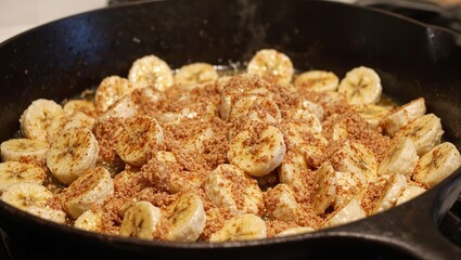 Delicious caramelized bananas sizzling in a cast iron skillet coated with brown sugar and cinnamon Irresistible dessert concept