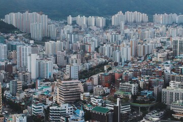 Aerial View of Dense Urban Skyline of Busan, South Korea, Featuring High-Rise Buildings and...