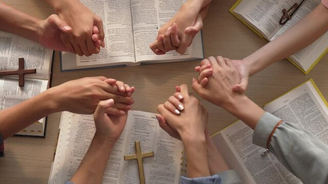 Sense of devotion and spiritual fulfill with christian catholic follower immerse in faith. Slow motion christian people practicing group prayer, holding hand while praying together. Burgeoning
